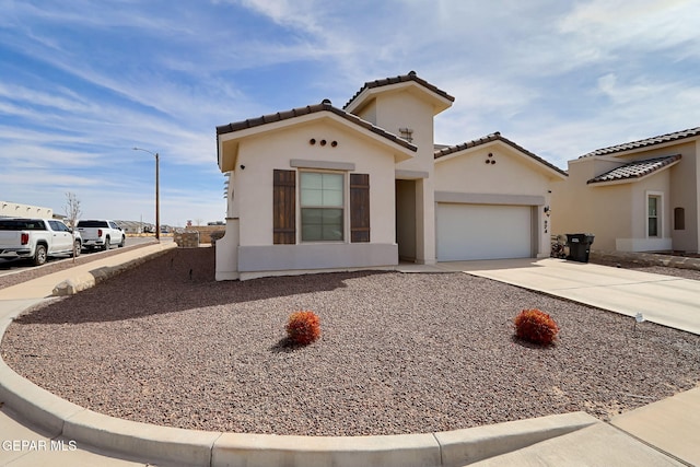 974 Airship Pl, Horizon City, TX 79928 - mediterranean / spanish-style home featuring concrete driveway, a garage, and stucco siding