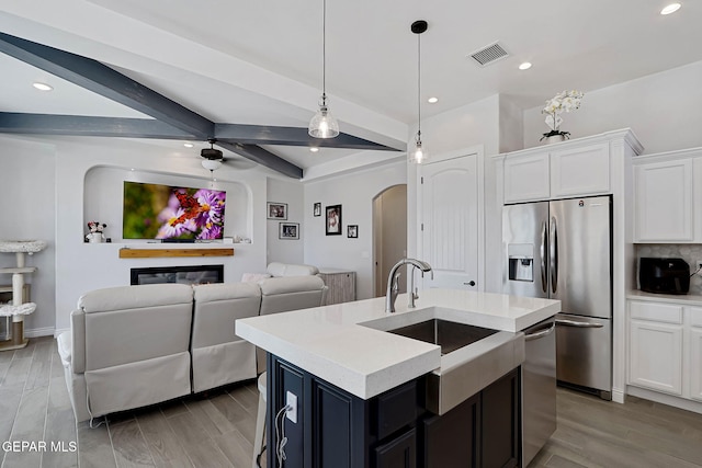 974 Airship Pl, Horizon City, TX 79928 - kitchen with arched walkways, appliances with stainless steel finishes, open floor plan, a sink, and light countertops