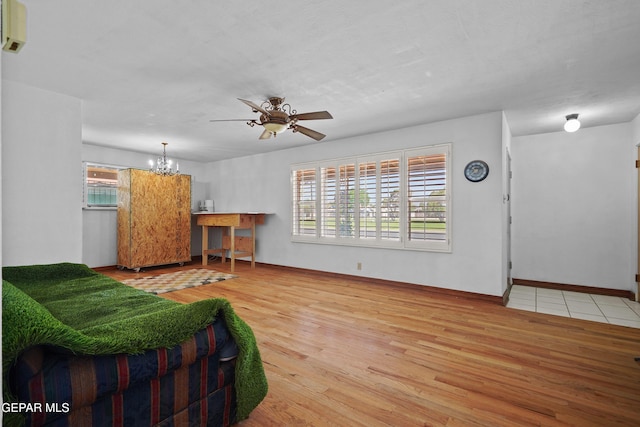 8108 Edgemere Blvd, El Paso, TX 79925 - living area featuring wood finished floors, a chandelier, ceiling fan, and baseboards