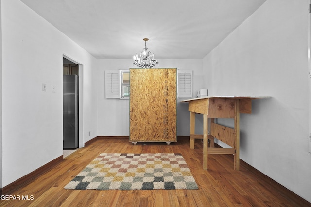 8108 Edgemere Blvd, El Paso, TX 79925 - dining area featuring a chandelier, wood finished floors, and baseboards