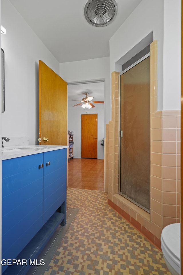 8108 Edgemere Blvd, El Paso, TX 79925 - bathroom with a stall shower, ceiling fan, vanity, and toilet