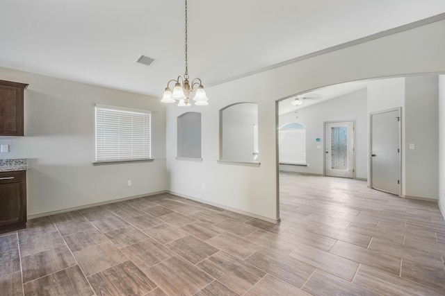 14294 Kayla Mia Dr, El Paso, TX 79938 - unfurnished dining area with wood tiled floors, a ceiling fan, a chandelier, baseboards, and lofted ceiling