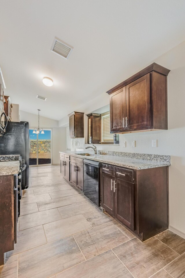 14294 Kayla Mia Dr, El Paso, TX 79938 - kitchen featuring black dishwasher, dark brown cabinetry, vaulted ceiling, stainless steel gas range oven, and a sink