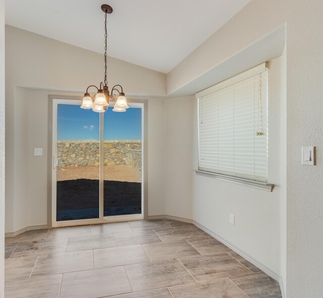 14294 Kayla Mia Dr, El Paso, TX 79938 - unfurnished dining area with a chandelier and lofted ceiling