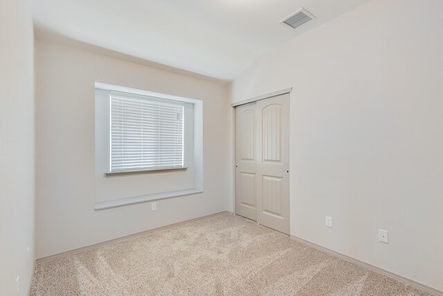 14294 Kayla Mia Dr, El Paso, TX 79938 - unfurnished bedroom with carpet, a closet, lofted ceiling, and baseboards