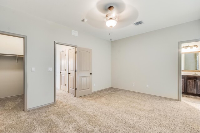 14294 Kayla Mia Dr, El Paso, TX 79938 - unfurnished bedroom with carpet floors, a spacious closet, ensuite bath, baseboards, and a closet