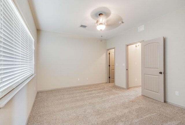 14294 Kayla Mia Dr, El Paso, TX 79938 - unfurnished bedroom featuring light carpet and ceiling fan