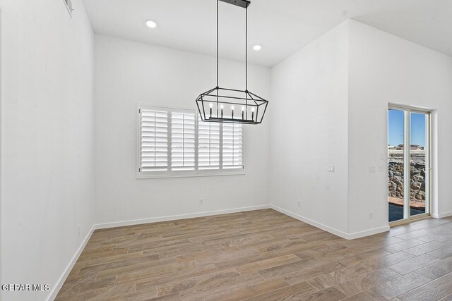 13797 Summer Wave Ave, El Paso, TX 79928 - unfurnished dining area with plenty of natural light, wood finished floors, a chandelier, baseboards, and recessed lighting