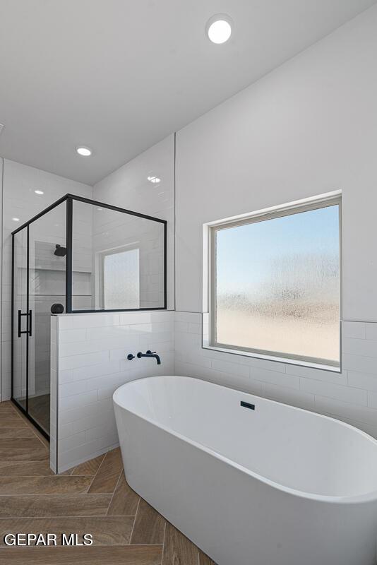13797 Summer Wave Ave, El Paso, TX 79928 - full bath with a freestanding tub, tile walls, and a shower stall