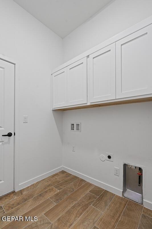 13797 Summer Wave Ave, El Paso, TX 79928 - laundry room with cabinet space, washer hookup, wood tiled floors, hookup for an electric dryer, and baseboards