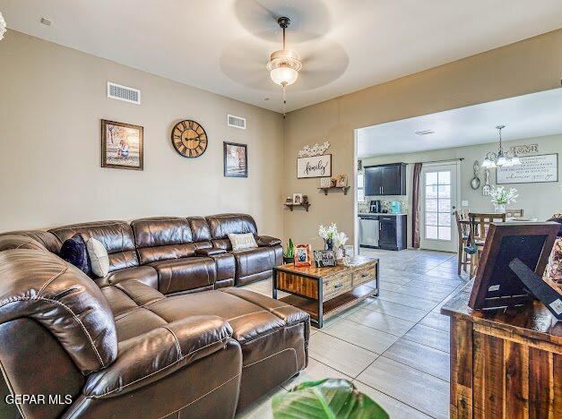 13649 Mill Hill Ct, El Paso, TX 79928 - living area with a ceiling fan, a chandelier, and light tile patterned floors