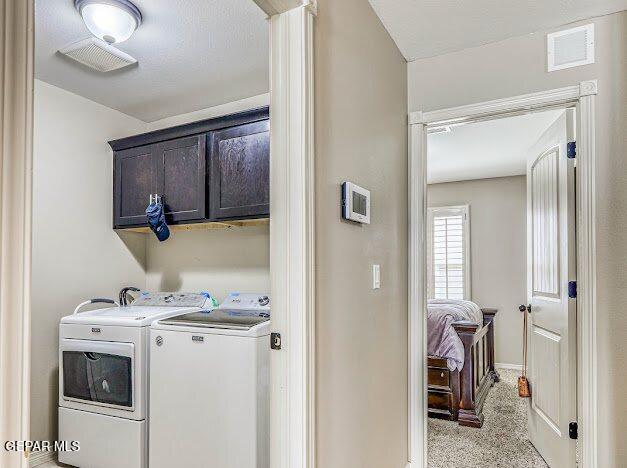 13649 Mill Hill Ct, El Paso, TX 79928 - washroom with cabinet space, separate washer and dryer, light colored carpet, and baseboards