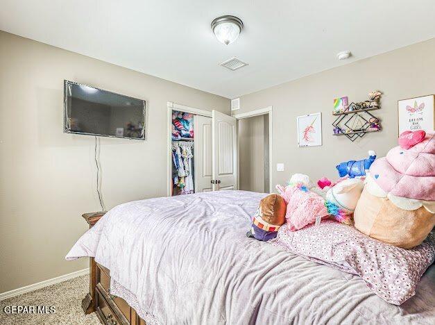13649 Mill Hill Ct, El Paso, TX 79928 - bedroom featuring a closet, baseboards, and light colored carpet