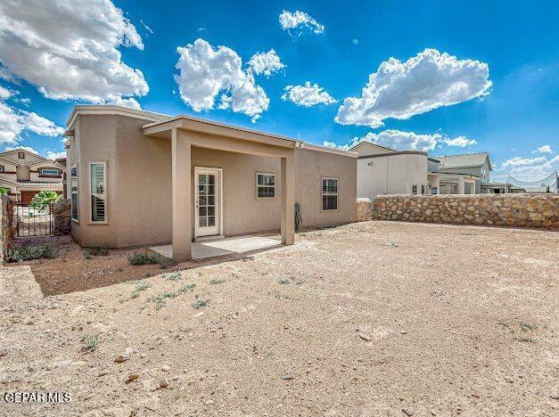 13649 Mill Hill Ct, El Paso, TX 79928 - back of property with stucco siding and a patio area