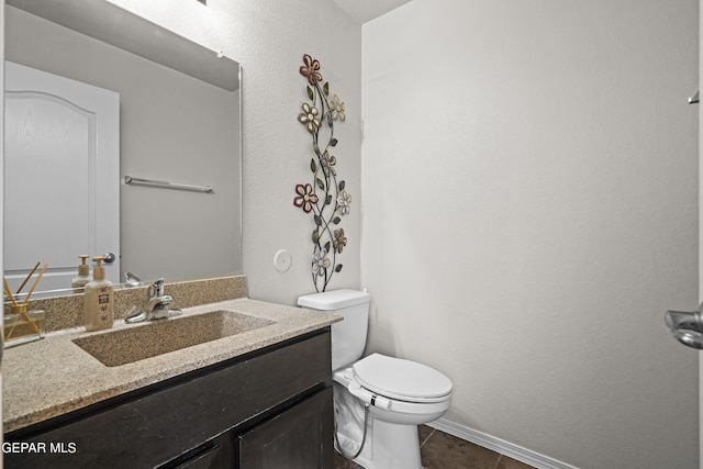 7237 Dust Storm Ln, El Paso, TX 79934 - bathroom featuring toilet, vanity, tile patterned floors, and baseboards