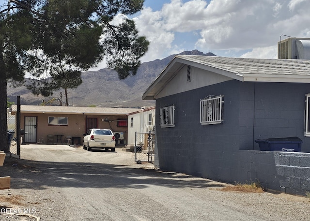 7511 Howard St, El Paso, TX 79904 - view of side of property featuring a mountain view and driveway