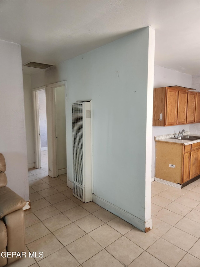 7511 Howard St, El Paso, TX 79904 - unfurnished living room with a heating unit, light tile patterned floors, and a sink