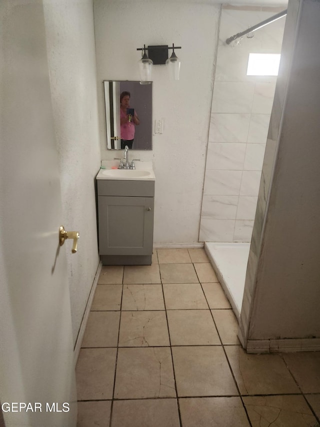 7511 Howard St, El Paso, TX 79904 - bathroom featuring vanity, a shower stall, tile patterned flooring, and baseboards