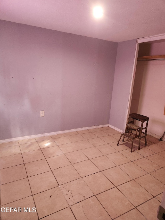 7511 Howard St, El Paso, TX 79904 - unfurnished bedroom featuring a closet, light tile patterned flooring, and baseboards