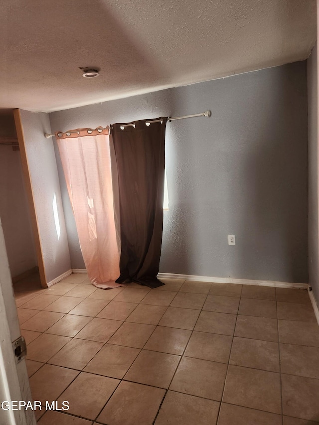 7511 Howard St, El Paso, TX 79904 - unfurnished room with light tile patterned floors and a textured ceiling