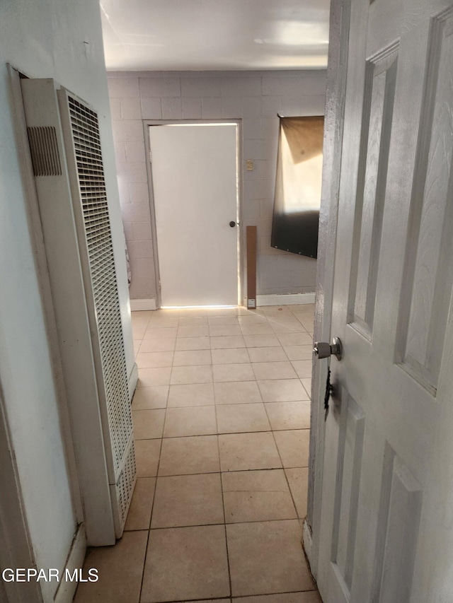 7511 Howard St, El Paso, TX 79904 - corridor with a heating unit, light tile patterned floors, and tile walls