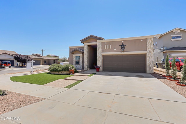 14701 Tim Hardaway, El Paso, TX 79938 - view of front facade with driveway, a garage, stucco siding, and a front lawn