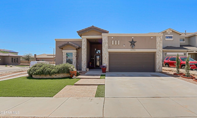 14701 Tim Hardaway, El Paso, TX 79938 - view of front facade with driveway, stucco siding, a front yard, and a garage