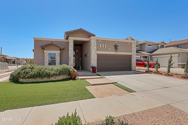 14701 Tim Hardaway, El Paso, TX 79938 - view of front of home with a garage, concrete driveway, stucco siding, a front yard, and a residential view