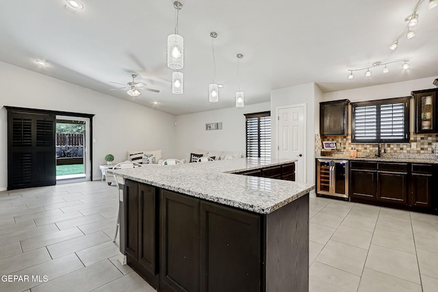 14701 Tim Hardaway, El Paso, TX 79938 - kitchen with beverage cooler, healthy amount of natural light, a ceiling fan, light tile patterned floors, and vaulted ceiling