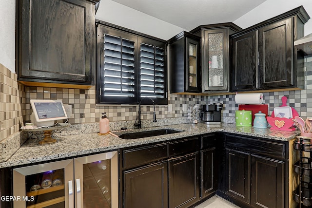 14701 Tim Hardaway, El Paso, TX 79938 - kitchen featuring a sink, beverage cooler, and light stone counters