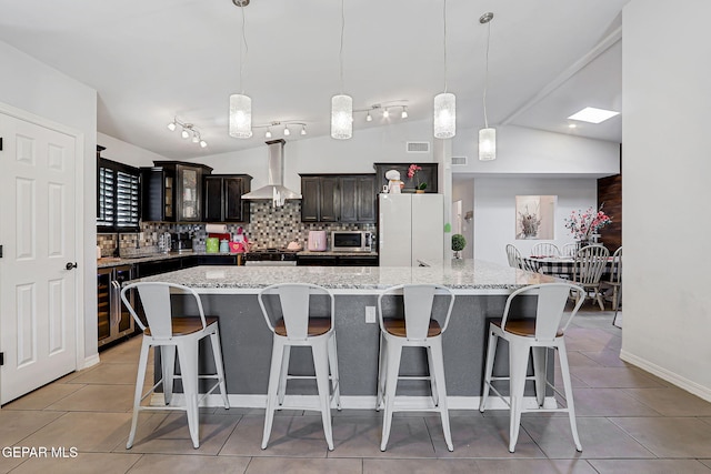 14701 Tim Hardaway, El Paso, TX 79938 - kitchen featuring ventilation hood, appliances with stainless steel finishes, tasteful backsplash, light tile patterned floors, and wine cooler