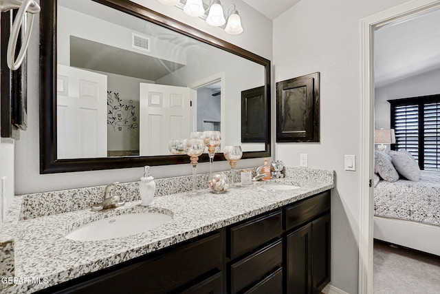14701 Tim Hardaway, El Paso, TX 79938 - ensuite bathroom featuring double vanity and baseboards