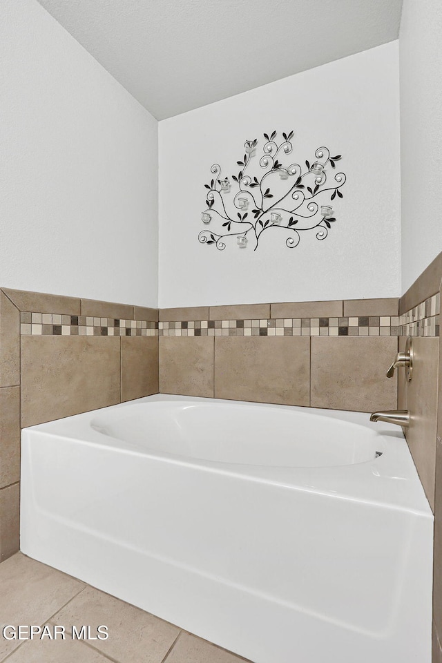 14701 Tim Hardaway, El Paso, TX 79938 - bathroom with a bath and tile patterned floors