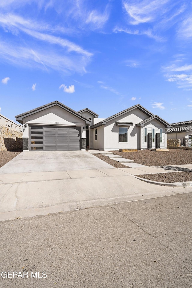 12264 Clifton Hill Rd, El Paso, TX 79928 - ranch-style house featuring a garage, concrete driveway, stucco siding, and a tile roof