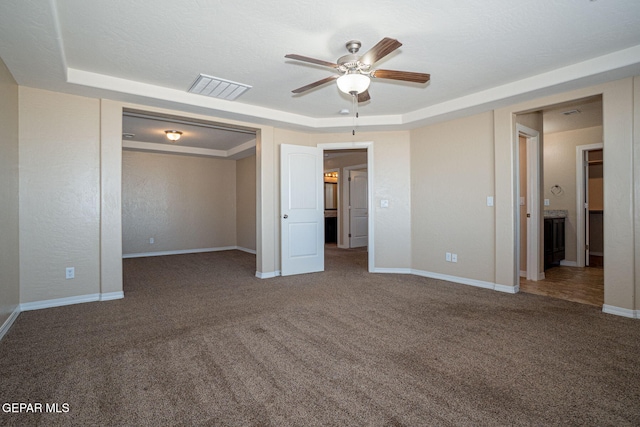 117 Camino Cresta Pl, Horizon City, TX 79928 - unfurnished bedroom featuring carpet floors, a tray ceiling, baseboards, and a ceiling fan