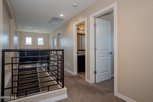 117 Camino Cresta Pl, Horizon City, TX 79928 - hall with an upstairs landing, carpet flooring, baseboards, and a textured wall