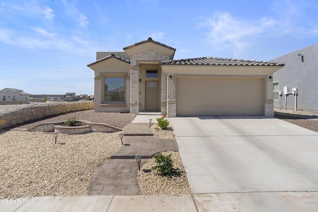 13142 Emerald Isle St, El Paso, TX 79928 - view of front of property featuring a garage, concrete driveway, a tiled roof, and stone siding