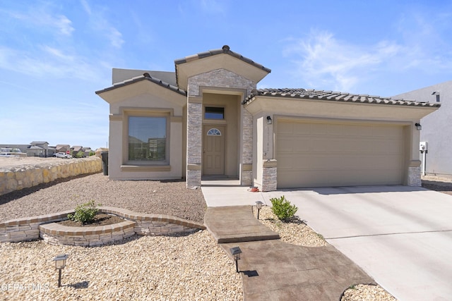 13142 Emerald Isle St, El Paso, TX 79928 - view of front of property with concrete driveway, an attached garage, stone siding, and stucco siding