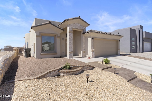 13142 Emerald Isle St, El Paso, TX 79928 - view of front facade featuring driveway, stucco siding, a garage, a tiled roof, and stone siding