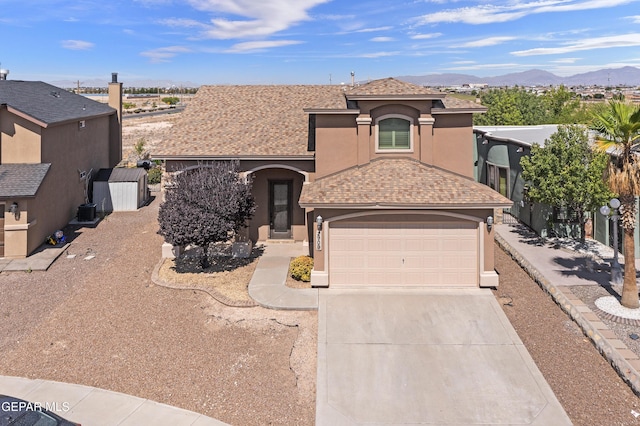 2909 Pino Triste Dr, El Paso, TX 79938 - view of front of property featuring stucco siding, driveway, a mountain view, a garage, and roof with shingles