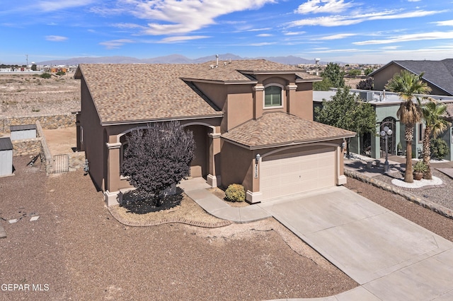 2909 Pino Triste Dr, El Paso, TX 79938 - view of front of house with stucco siding, a mountain view, an attached garage, and concrete driveway
