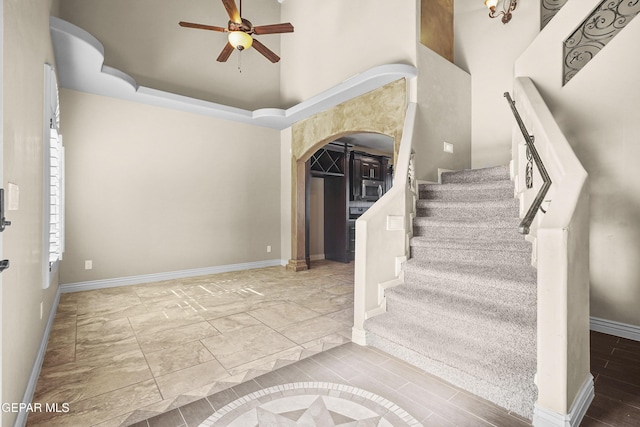 2909 Pino Triste Dr, El Paso, TX 79938 - stairway featuring ceiling fan and arched walkways