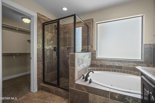 2909 Pino Triste Dr, El Paso, TX 79938 - bathroom featuring a stall shower, a tub with jets, a spacious closet, and vanity