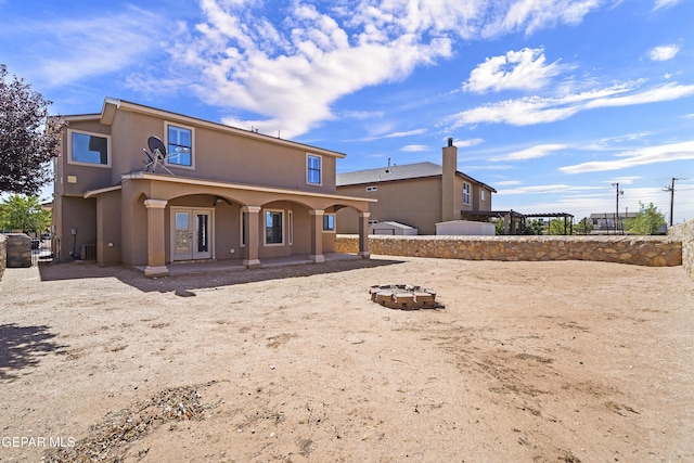 2909 Pino Triste Dr, El Paso, TX 79938 - back of property with stucco siding and an outdoor fire pit