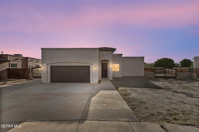 6037 Vicente Gomez Ln, El Paso, TX 79932 - mediterranean / spanish-style home with a gate, concrete driveway, a garage, and stucco siding