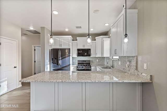 6037 Vicente Gomez Ln, El Paso, TX 79932 - kitchen with stainless steel appliances, a sink, backsplash, a peninsula, and light stone counters