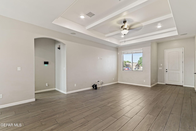 6037 Vicente Gomez Ln, El Paso, TX 79932 - empty room featuring a raised ceiling, arched walkways, a ceiling fan, dark wood-style flooring, and recessed lighting