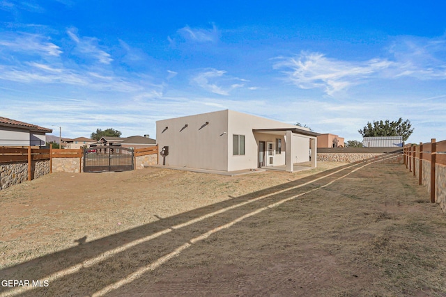 6037 Vicente Gomez Ln, El Paso, TX 79932 - back of house with a fenced backyard and stucco siding