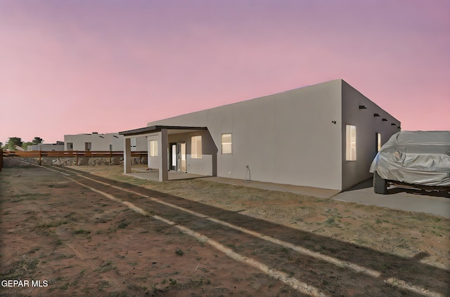 6037 Vicente Gomez Ln, El Paso, TX 79932 - back of house at dusk with stucco siding