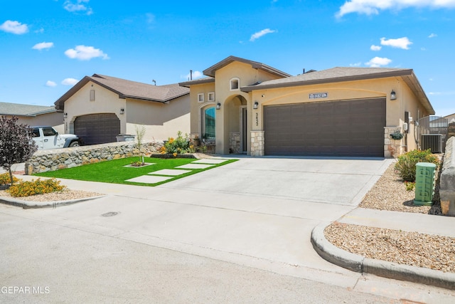 3452 David Palacio Dr, El Paso, TX 79938 - view of front of property with a garage, stone siding, stucco siding, and driveway